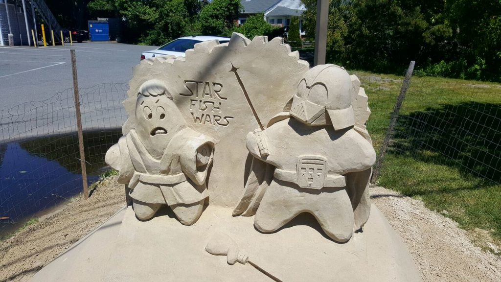 sand sculpture of star fish dressed as Star Wars characters